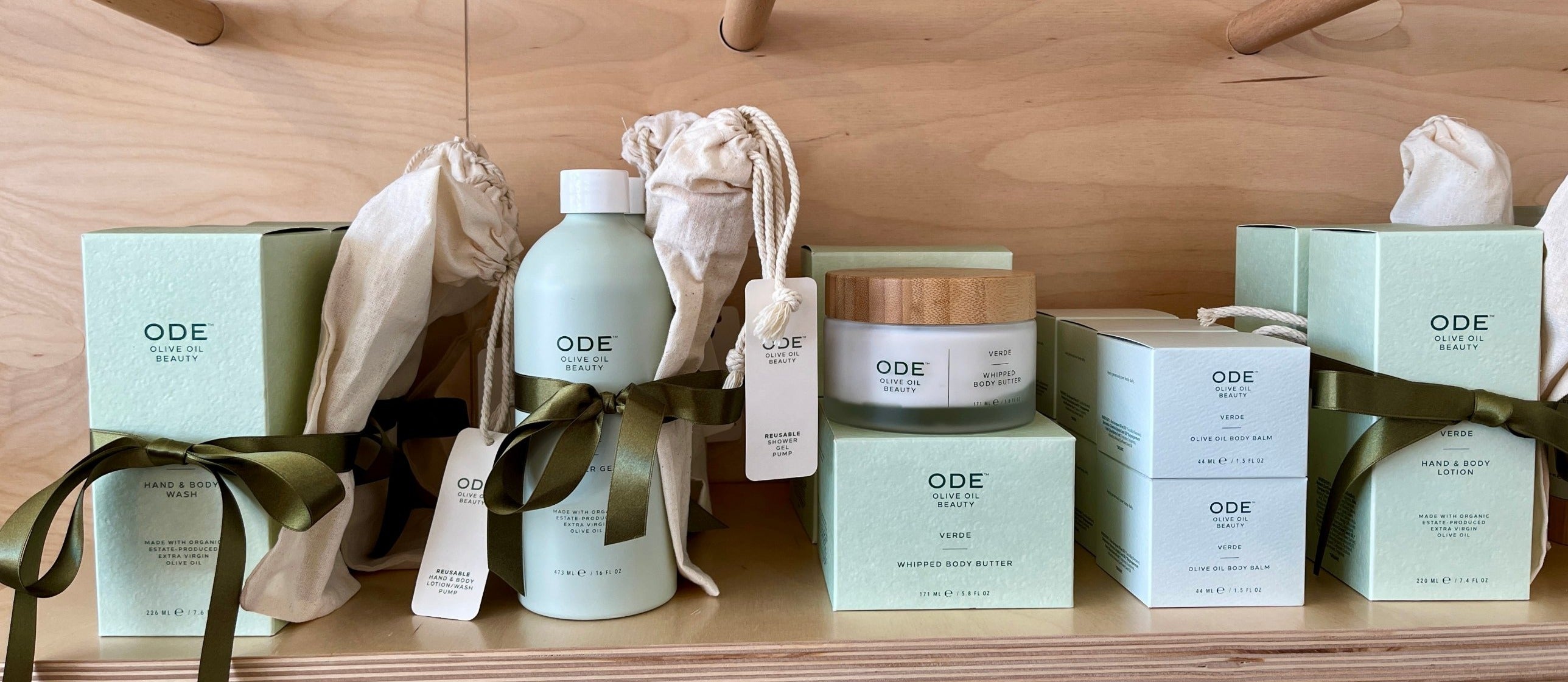 ODE olive oil body care on a plywood shelf at PHYLUM Palm Springs