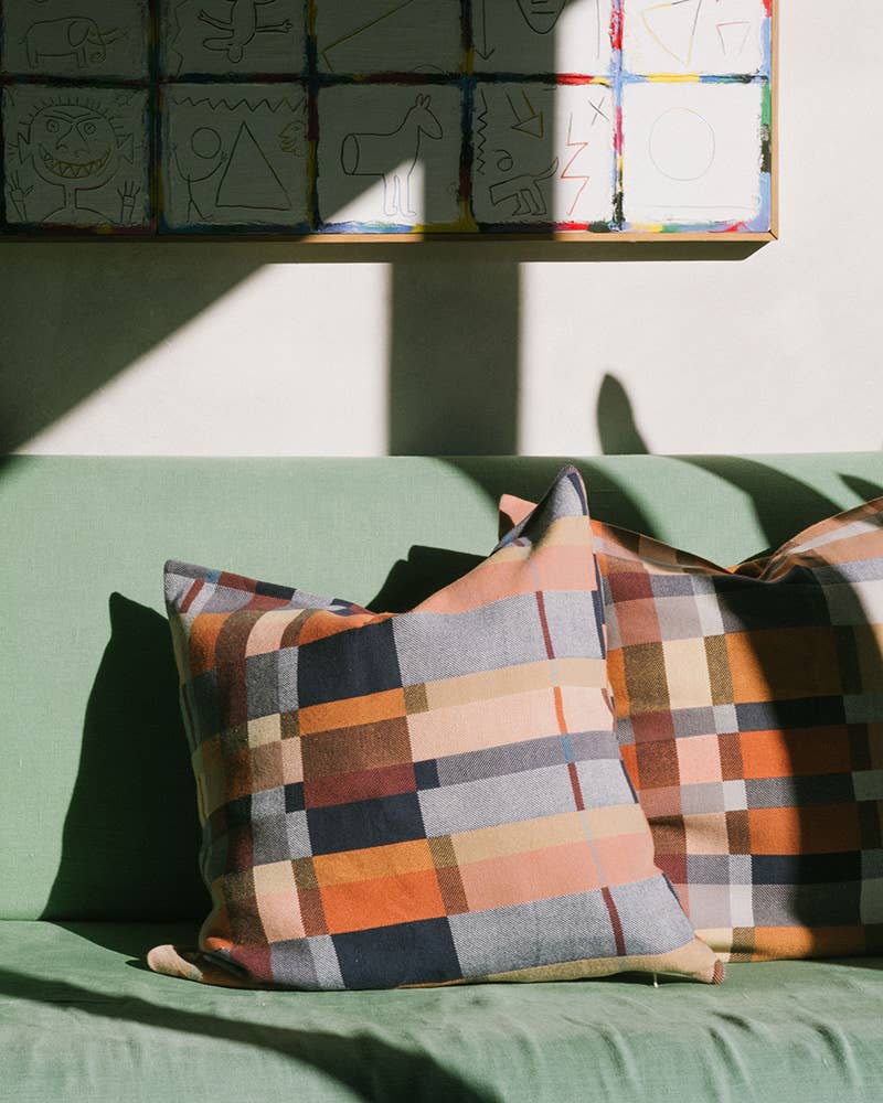 Mungo Double Cloth Cushion in Karoo styled on a green sofa