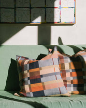 Mungo Double Cloth Cushion in Karoo styled on a green sofa