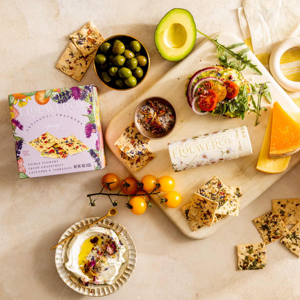 Apéritif crackers arranged on a grazing board with cheese and fresh fruit
