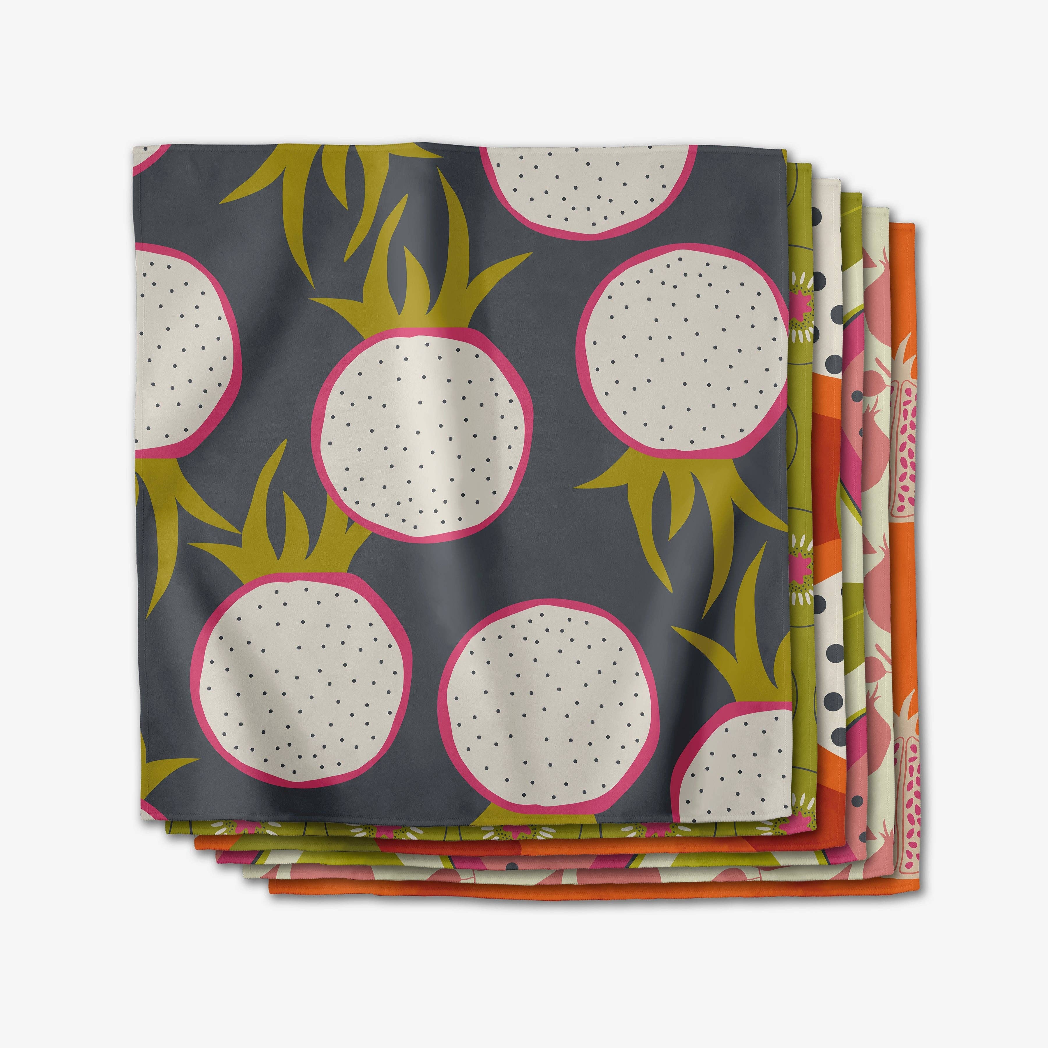 Stack of Tropical Fruit dinner napkins, oversized dragon fruit in cream and chartreuse on slate