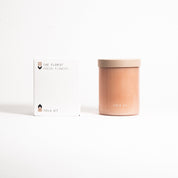 The Florist Candle in a blush glass jar with its printed box