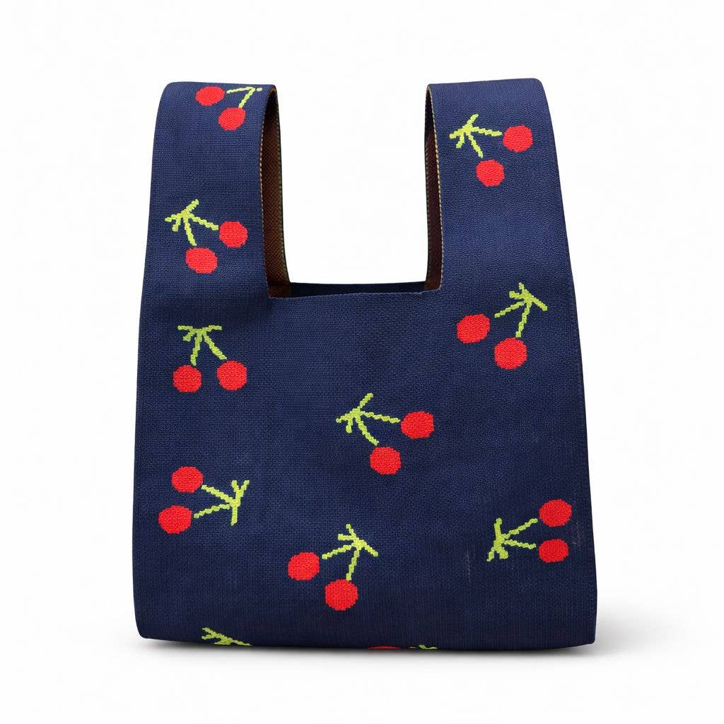 Navy knitted bag with red cherry pattern, front view with cut-out top handles