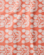 Close-up of the Graphic Daisies print, white daisy sprigs on a coral ground
