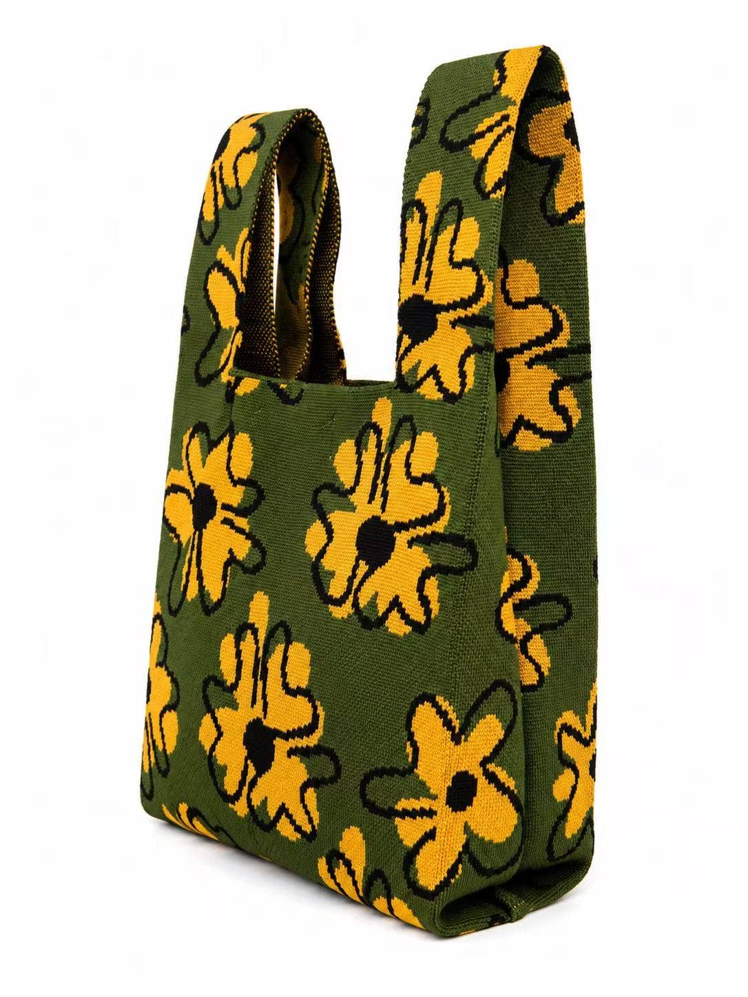 Side view of the golden flower knitted tote bag in moss green, showing its shoulder handles
