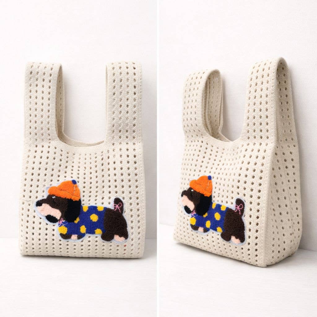 Cream open-knit handbag with an embroidered dachshund patch in an orange hat, shown from the front and side