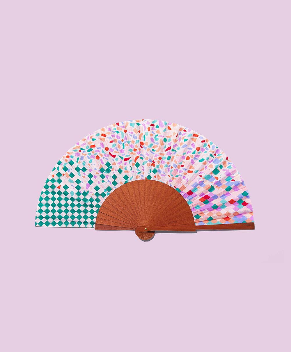 A FAN OF handmade fan in Gaudi Trencadis, a mosaic shard print in coral, teal and lilac with a green diamond check panel on a wooden frame