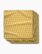 Stack of Sunny Sun dinner napkins, rows of small golden suns on a butter-yellow ground