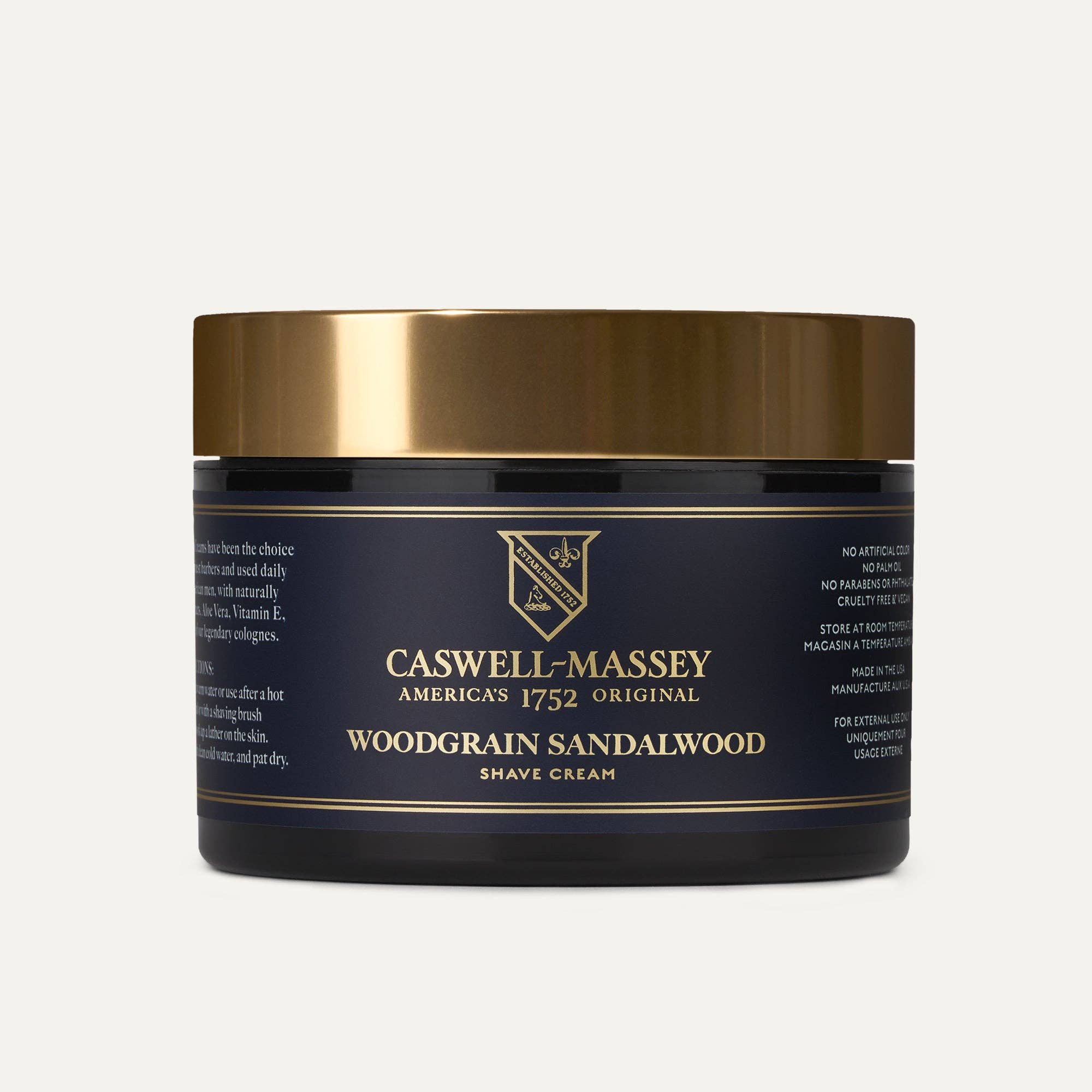 Caswell-Massey Woodgrain Sandalwood Shave Cream in a navy jar with a gold lid