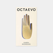 OCTAEVO Hamsa bookmark, brass hand shape with blue detail on its printed card