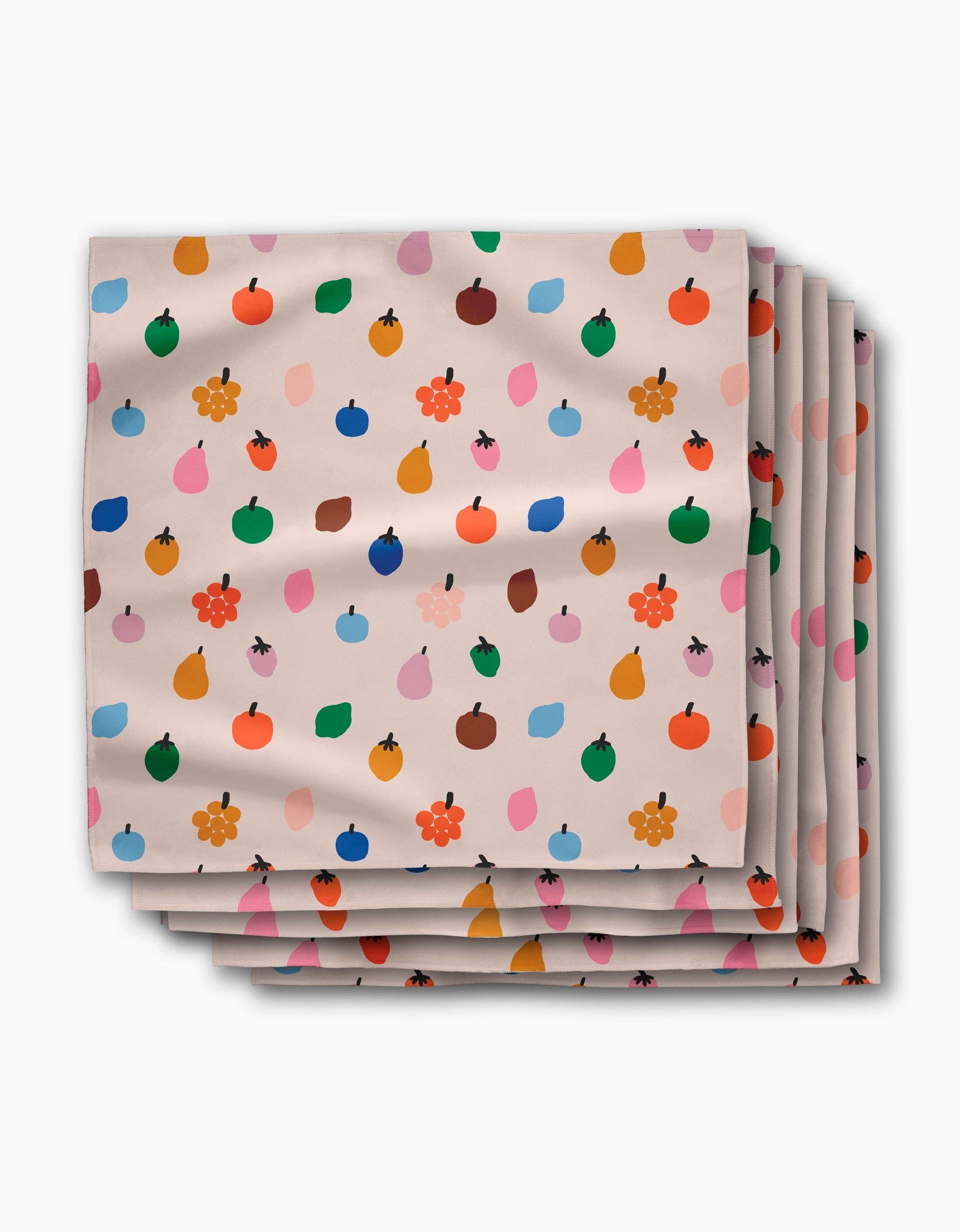 Stack of Fruit Basket dinner napkins, small apples, pears and blossoms on a pale blush ground