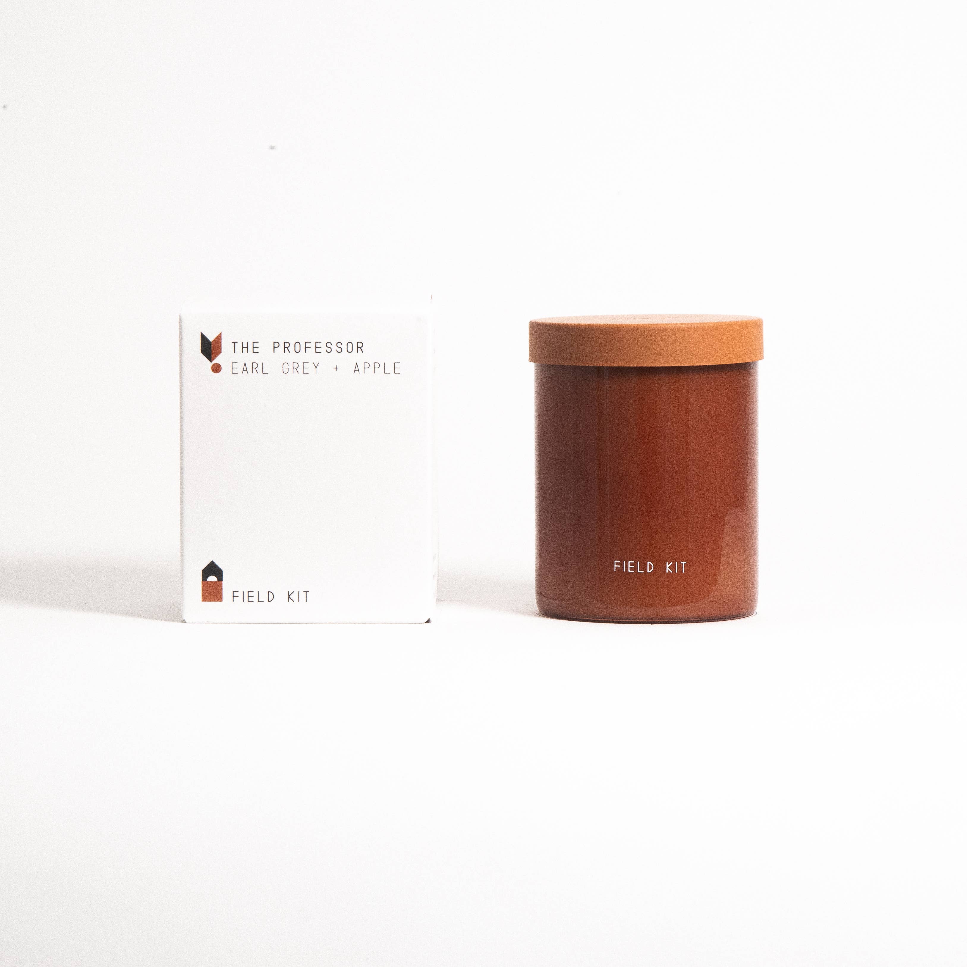 The Professor Candle in a rust glass jar with its printed box