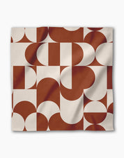 Circle Playground napkin draped to show the terracotta and cream geometric repeat