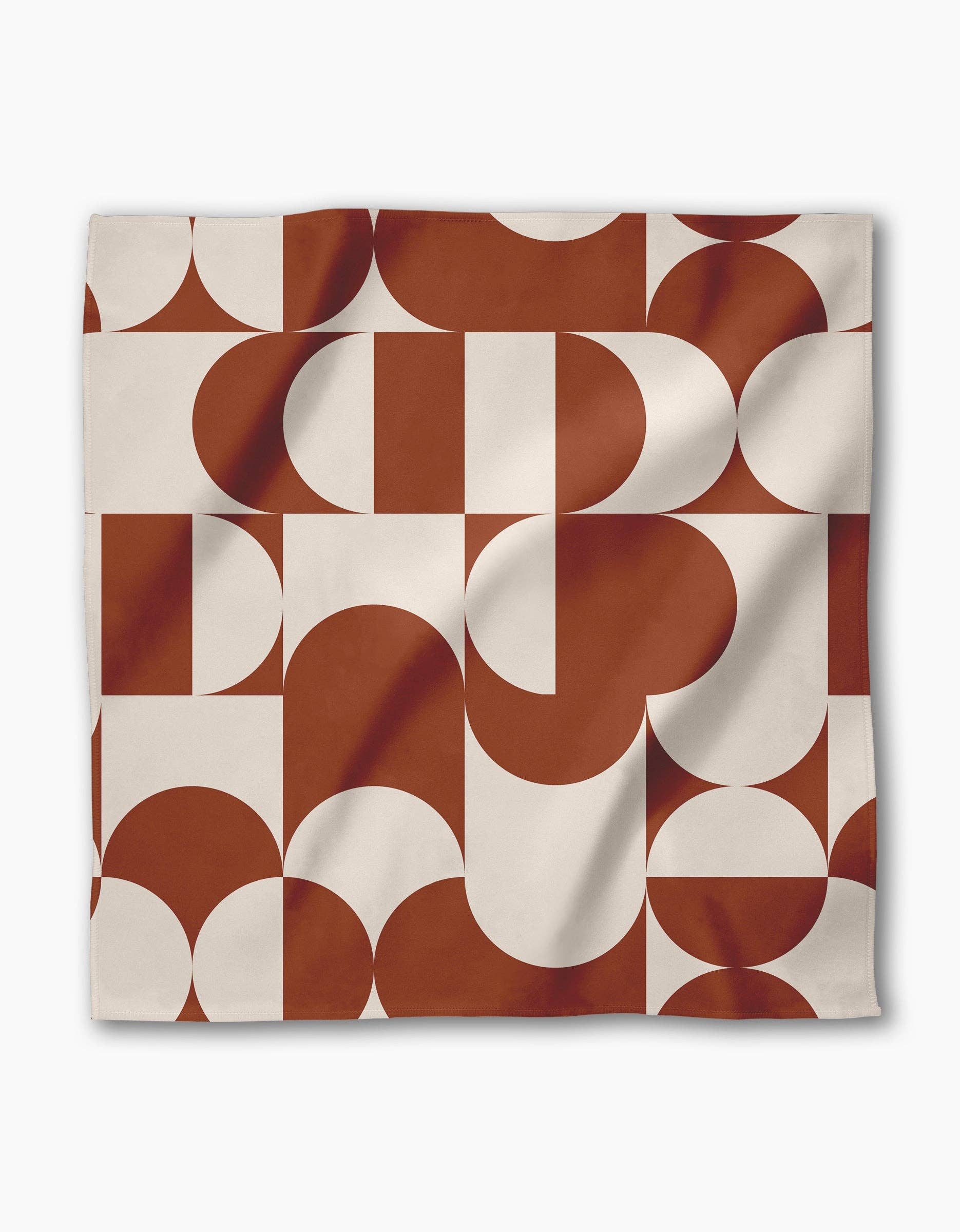 Circle Playground napkin draped to show the terracotta and cream geometric repeat