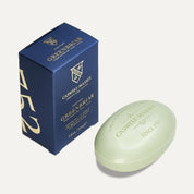 Caswell-Massey Greenbriar bar soap, a pale green oval bar embossed with the crest, beside its navy and gold box