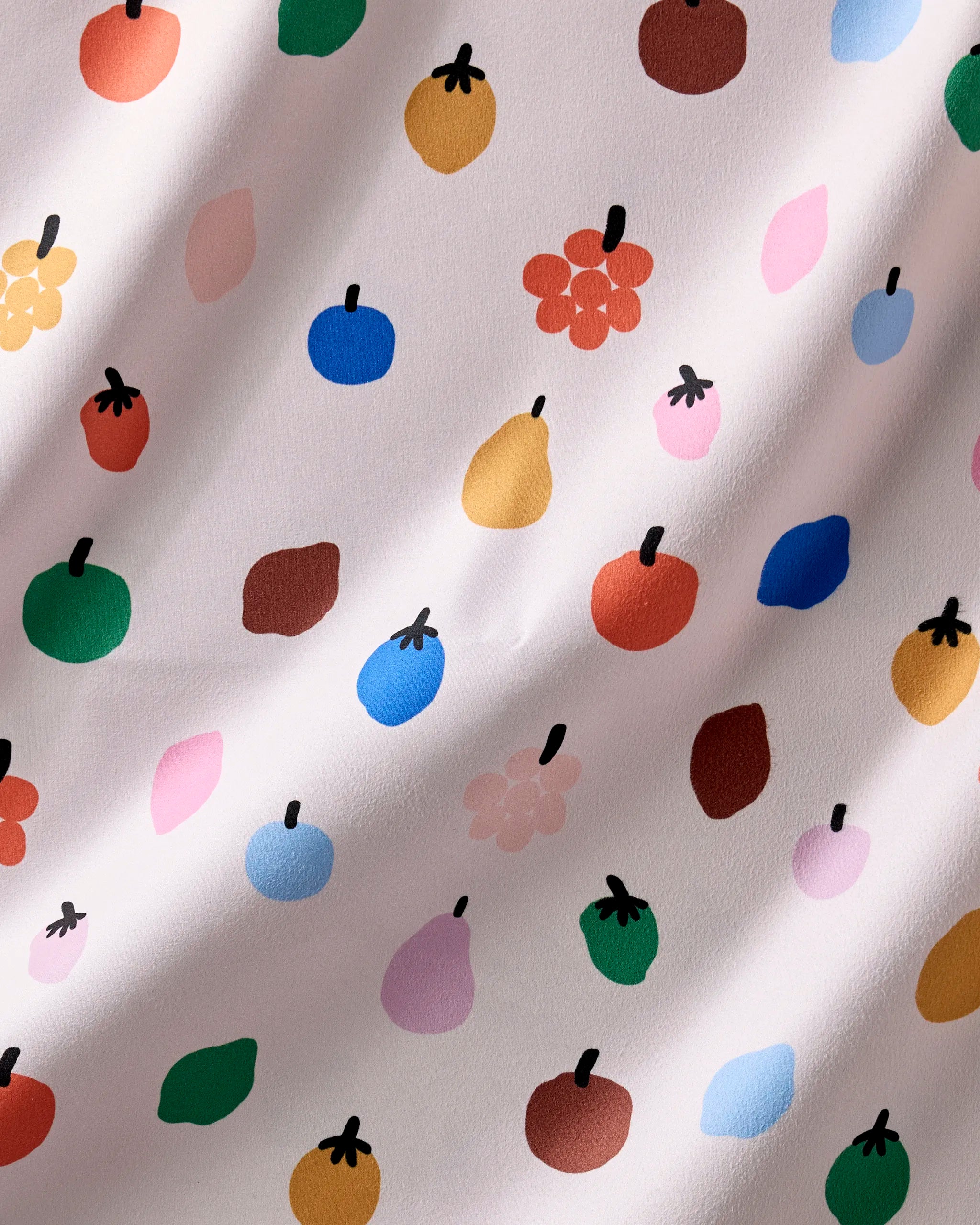 Close-up of the Fruit Basket print, stylized fruit shapes in red, green, blue, yellow and pink