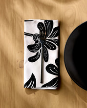 Giant Lush Floral napkin folded on a wooden table with a fork resting on top