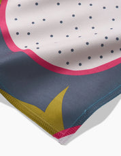 Close-up of the dragon fruit napkin corner, showing the Geosuede weave and stitched hem