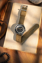 1956 Marine Black Gilt resting on book