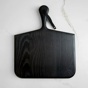 Norr Board in ebonized ash by KHEM Studios, matte black paddle serving board