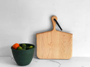 Norr Board in Maple standing beside a green bowl of citrus