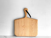 KHEM Studios Norr Board in Maple, squared paddle shape with a tapered handle and leather strap