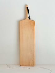 KHEM Studios Monster Board in Maple shown upright with its leather hanging strap