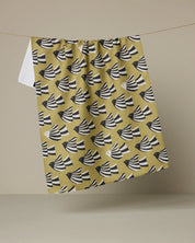 Geometry Alva kitchen tea towel, black and white birds in flight on a mustard ground