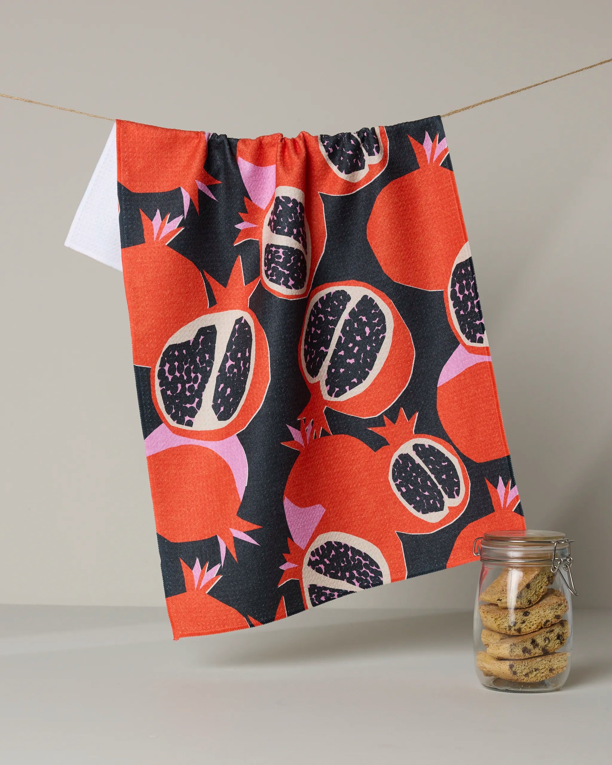 Geometry Graphic Pomegranates kitchen tea towel, halved pomegranates in orange and charcoal