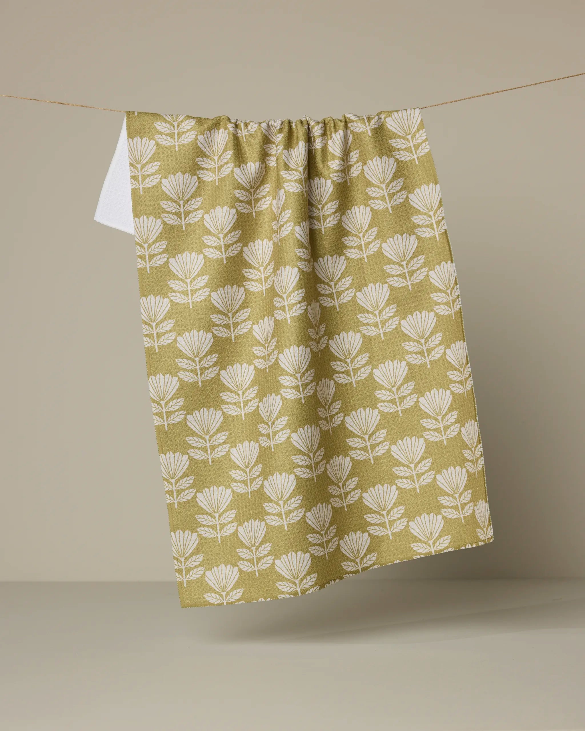 Geometry Ingrid kitchen tea towel, cream fan-shaped blooms on a chartreuse ground