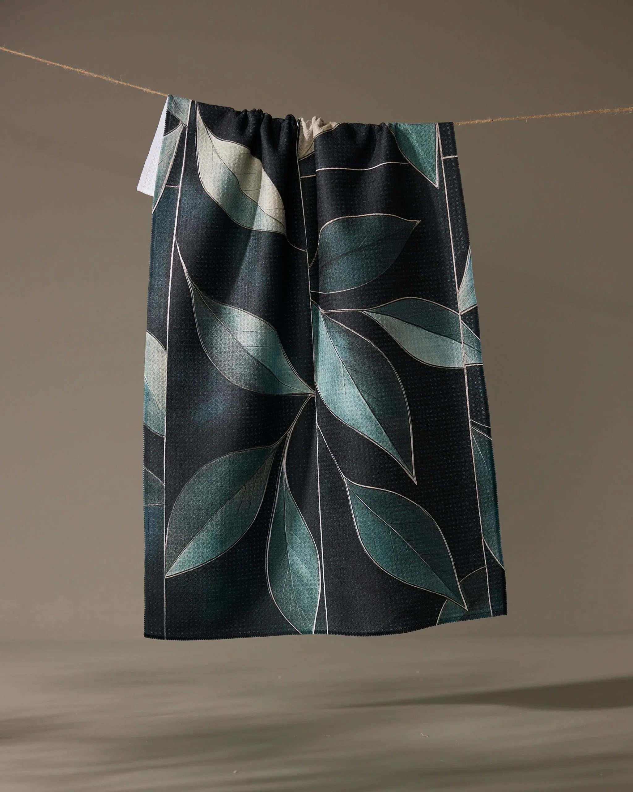 Geometry Modern Organic kitchen tea towel, sage and seafoam leaves on a near-black ground