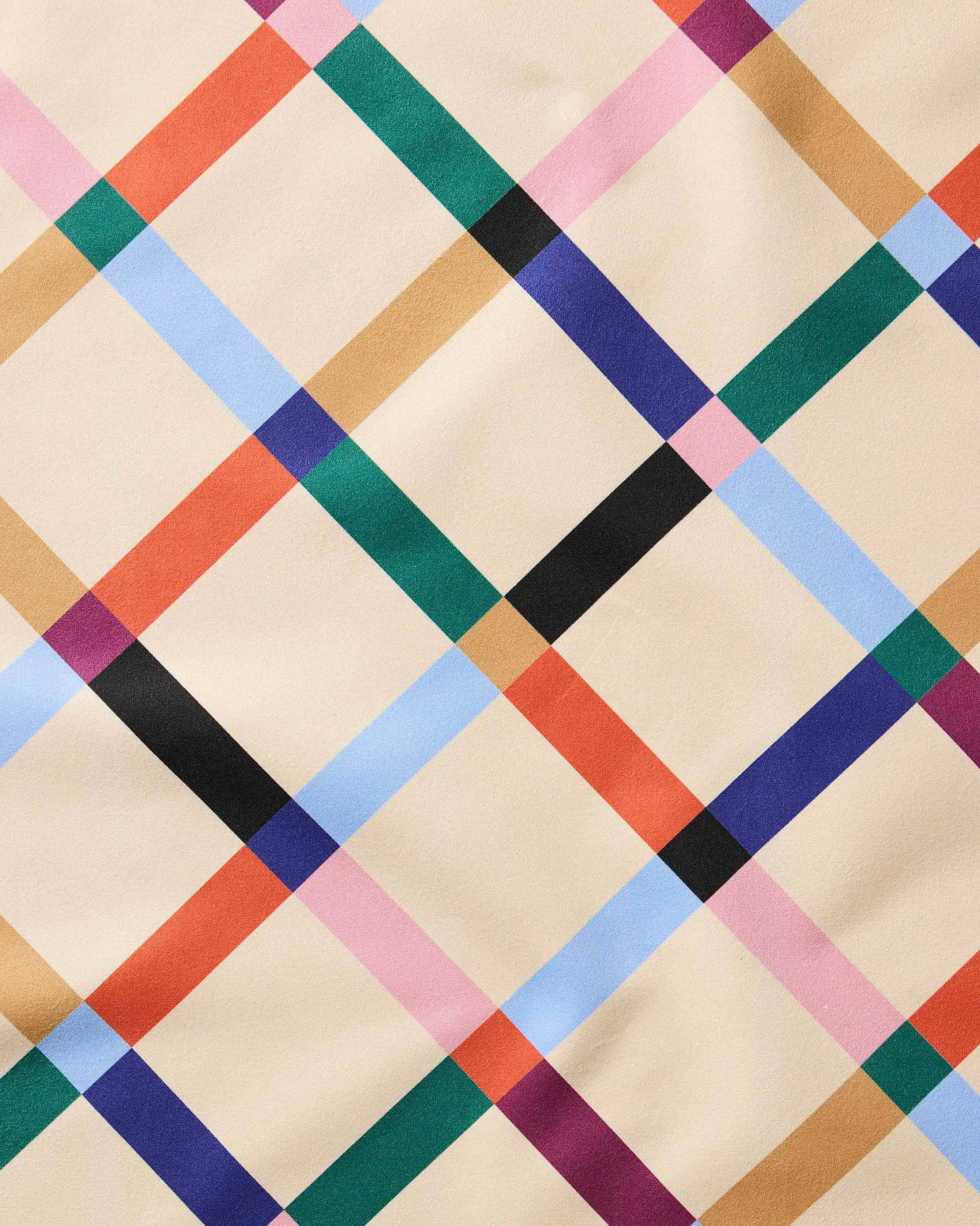 Close-up of the Cool Grid weave, diagonal bands of black, teal, blue, coral and tan on cream