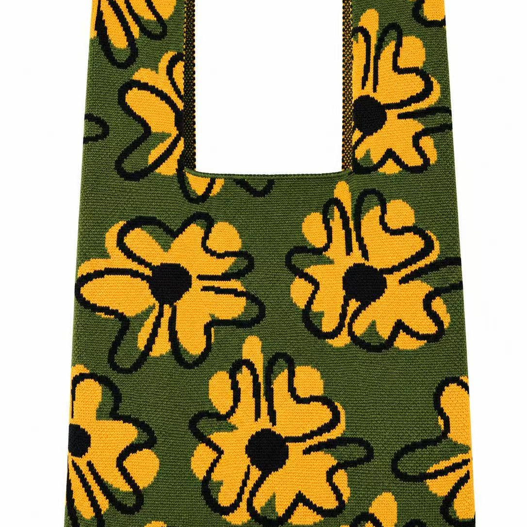 Knitted tote bag with oversized golden yellow flowers on a moss green background