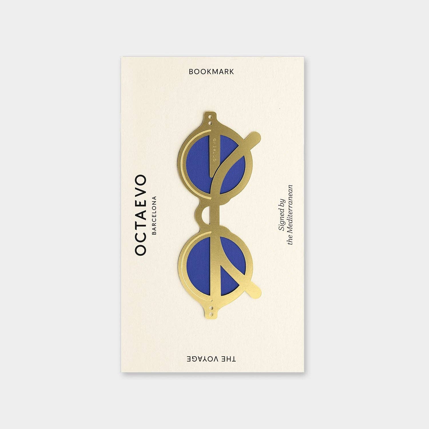 OCTAEVO The Voyage bookmark, brass sunglasses shape with blue lenses on its printed card