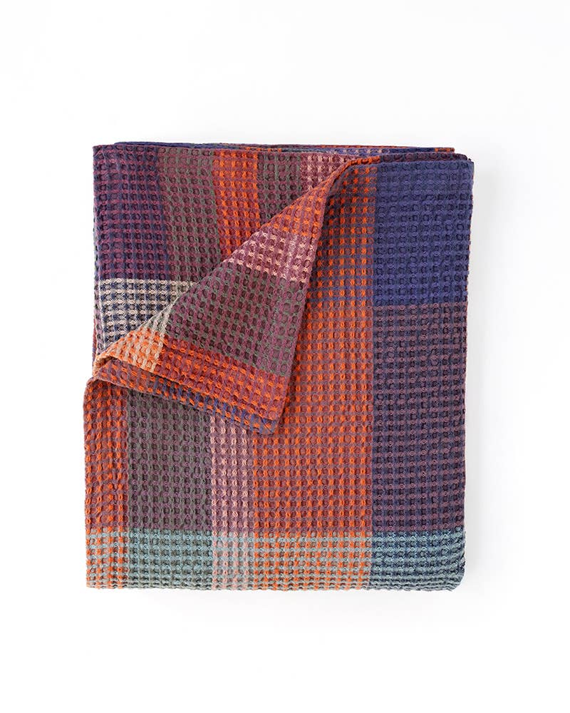 Mungo Vrou-Vrou Queen Blanket in Nebula, a rust, purple and navy waffle weave, folded