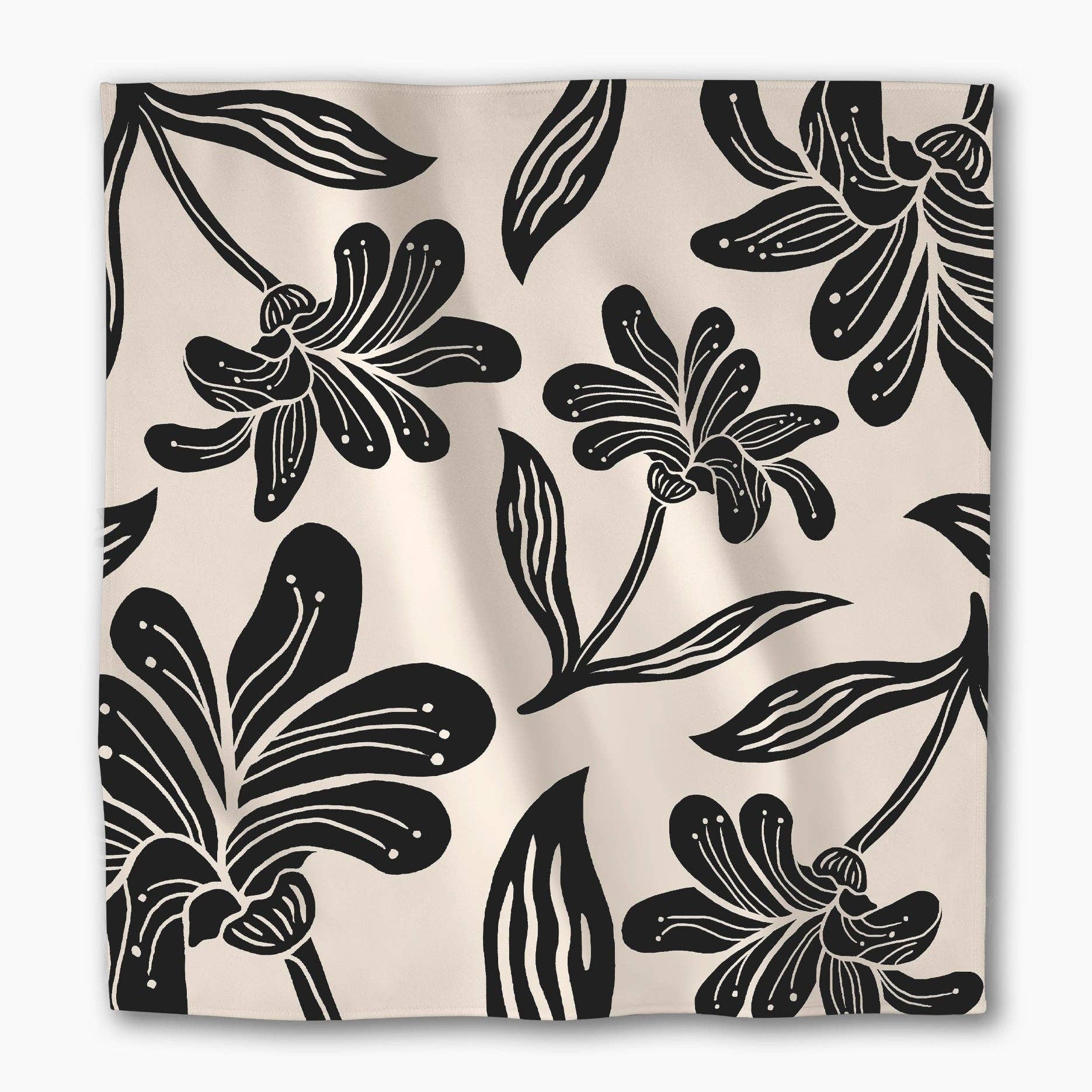 Single Giant Lush Floral napkin laid flat, showing the full black floral repeat on cream