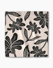 Single Giant Lush Floral napkin laid flat, showing the full black floral repeat on cream