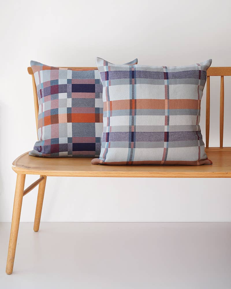 Two Mungo Double Cloth Cushions paired on a wooden bench