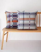 Two Mungo Double Cloth Cushions paired on a wooden bench