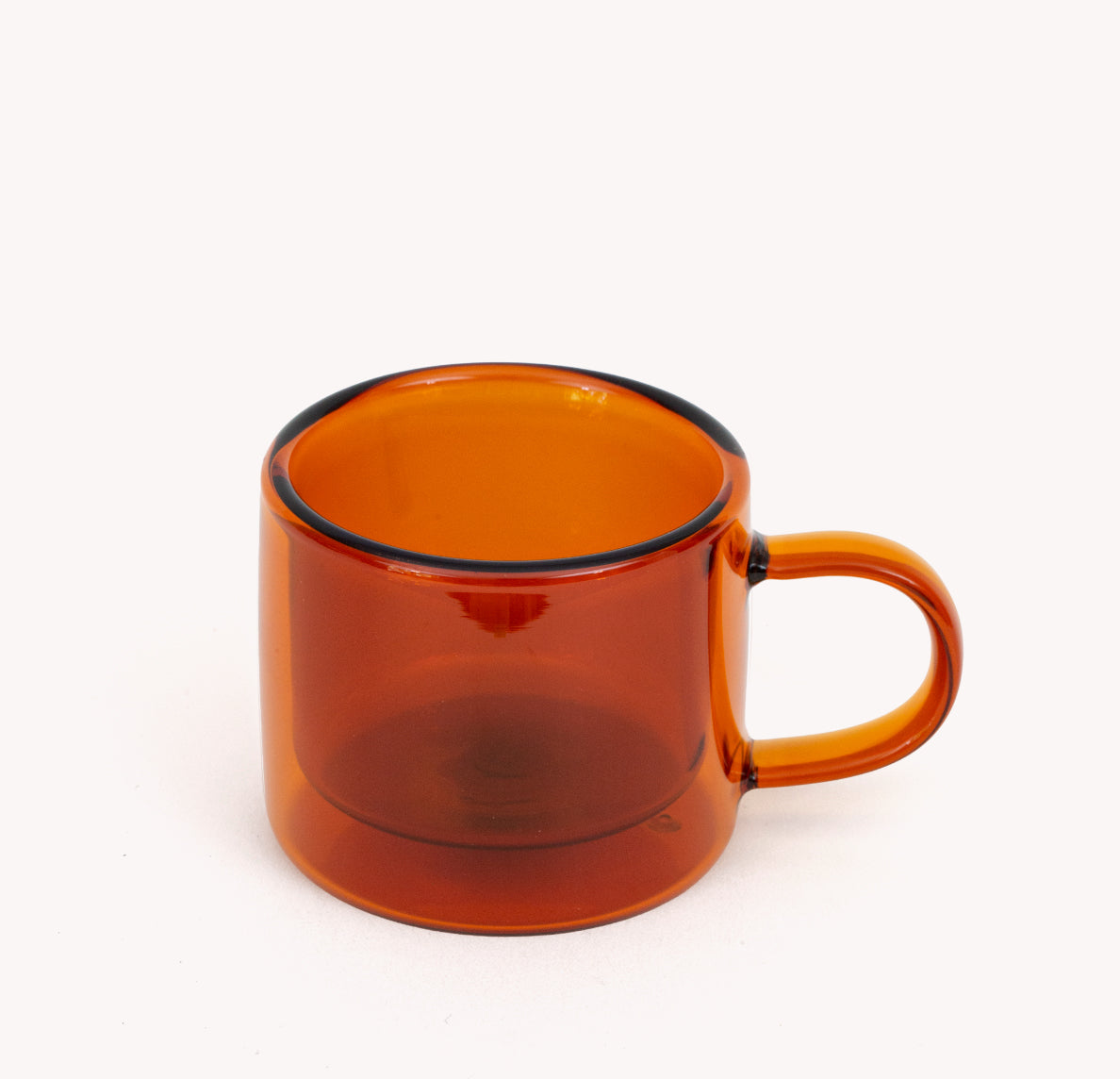 Gry Mattr double-walled espresso cup in amber borosilicate glass with a curved handle