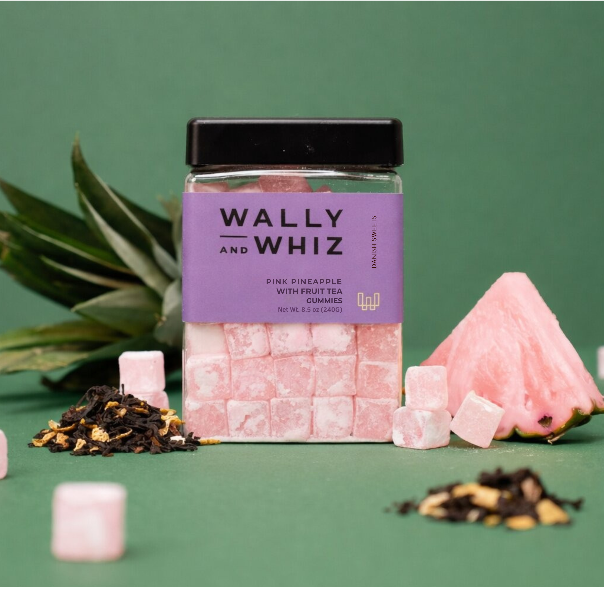 Wally and Whiz pink pineapple with fruit tea gummies in a lilac 8.5 oz jar, with pineapple and loose tea
