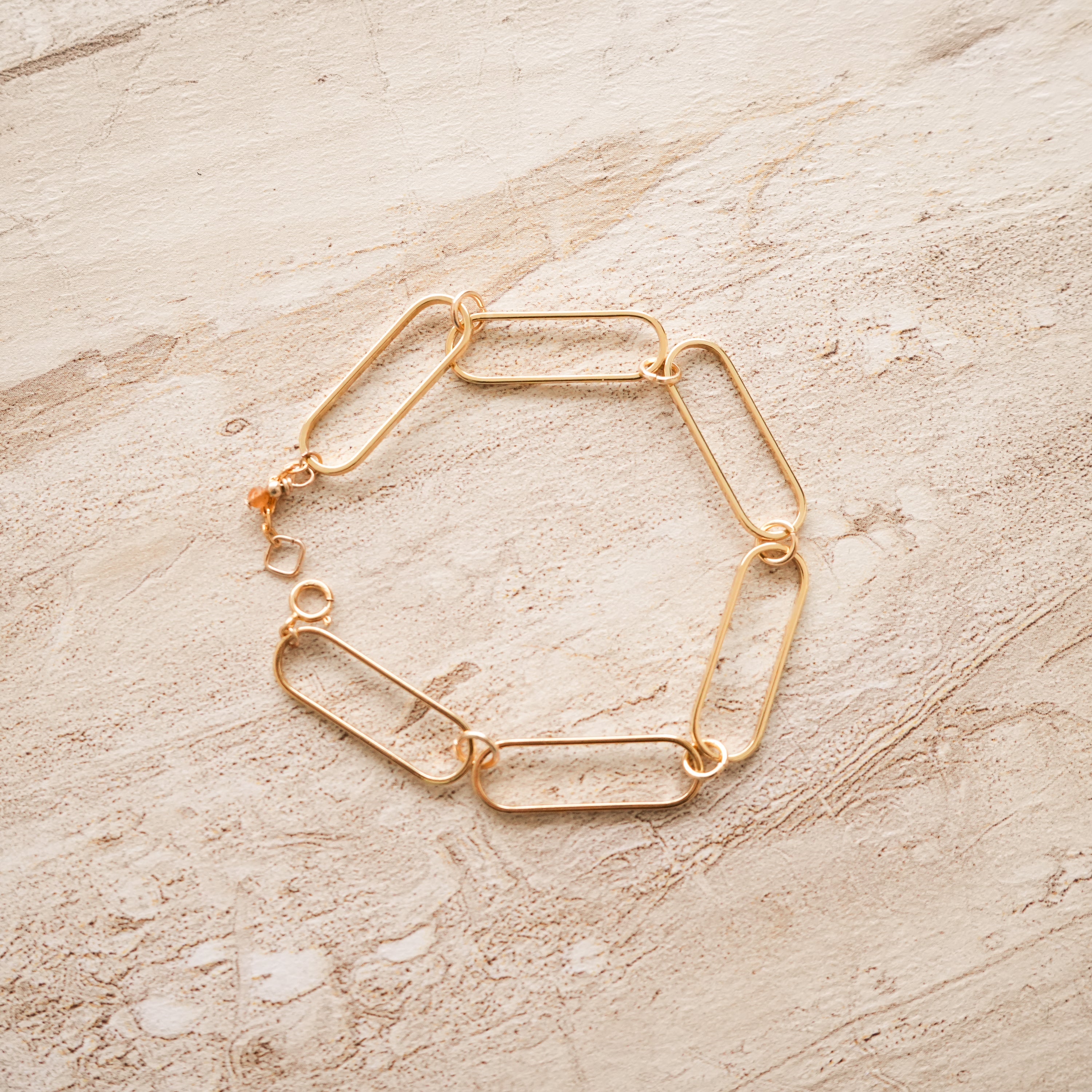 So Niice Reach Bracelet, gold paperclip link with a tiger's eye charm