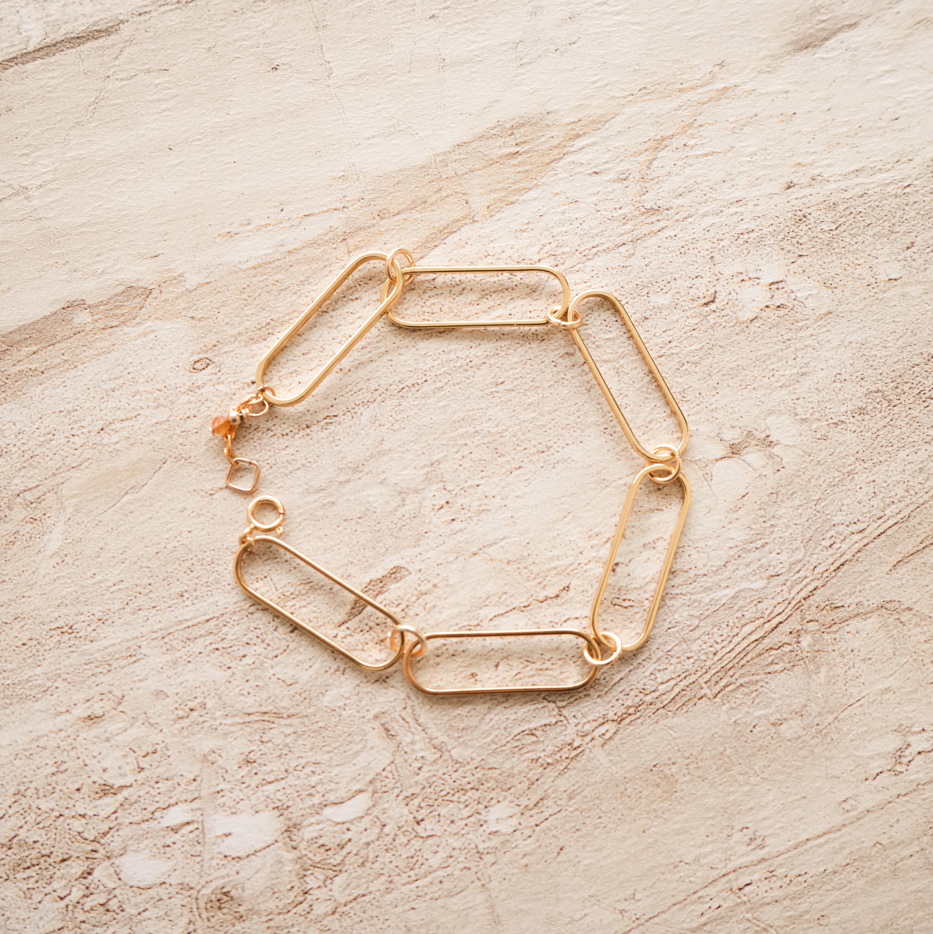 So Niice Reach Bracelet, gold paperclip link with a tiger's eye charm