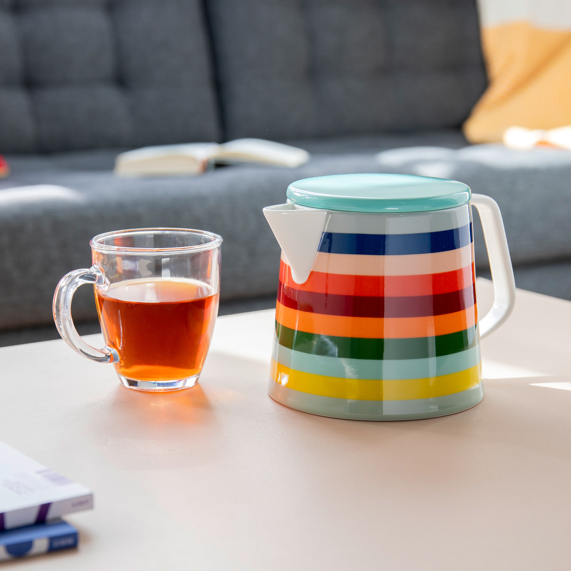 Remember Lorenzo teapot styled on a table with a cup of tea