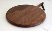 Round Board in walnut by KHEM Studios, on a marble surface